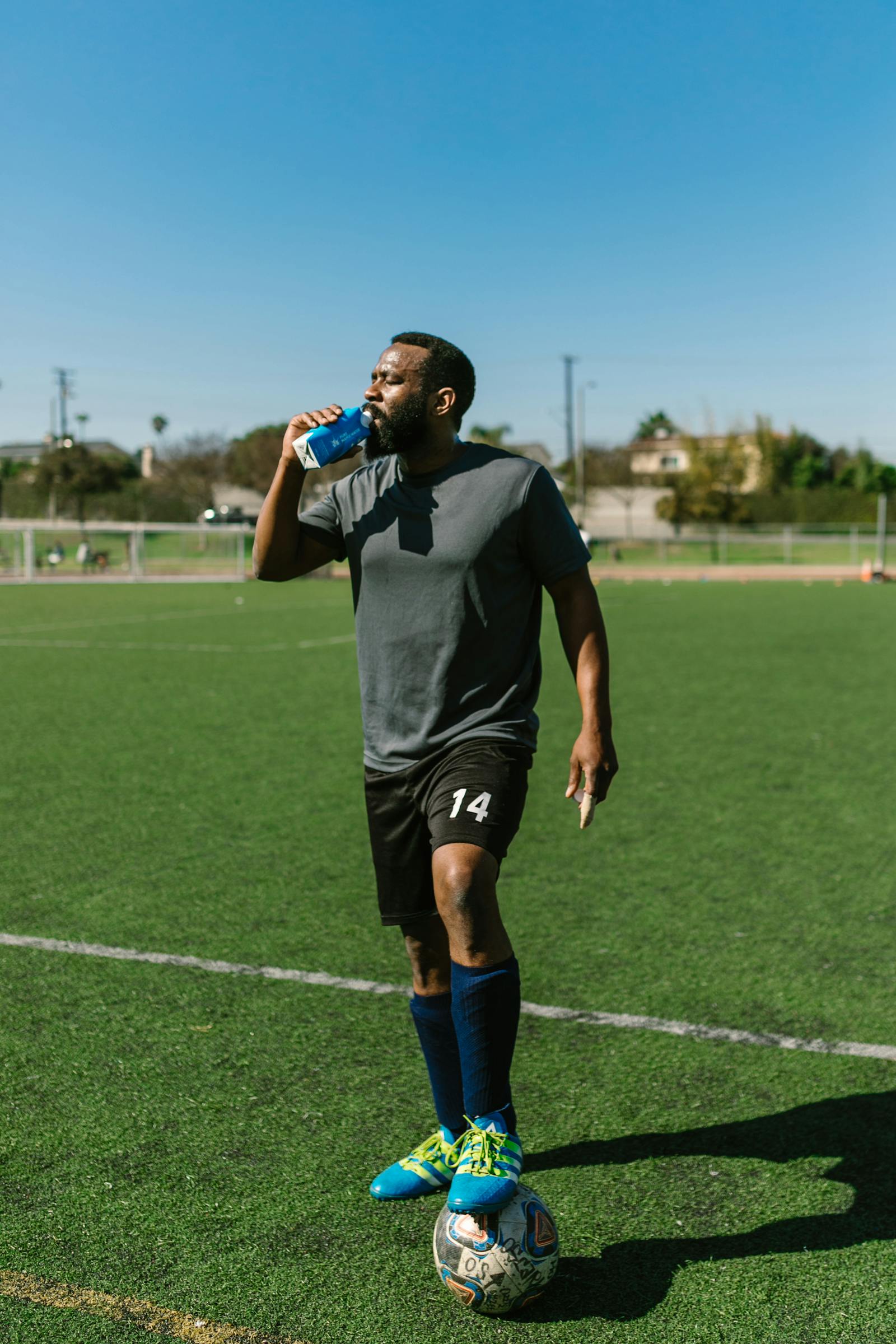 Soccer player taking a water break during training to replace fluid lost from sweating